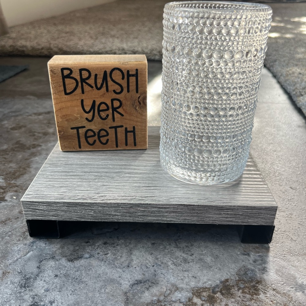Bathroom set; sign and toothbrush holder
